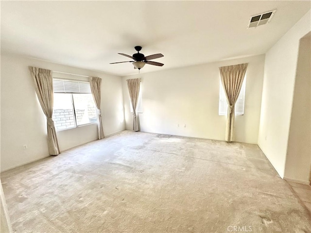 carpeted spare room with ceiling fan