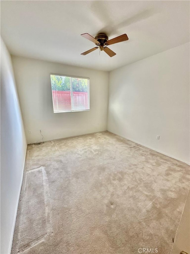 carpeted empty room featuring ceiling fan