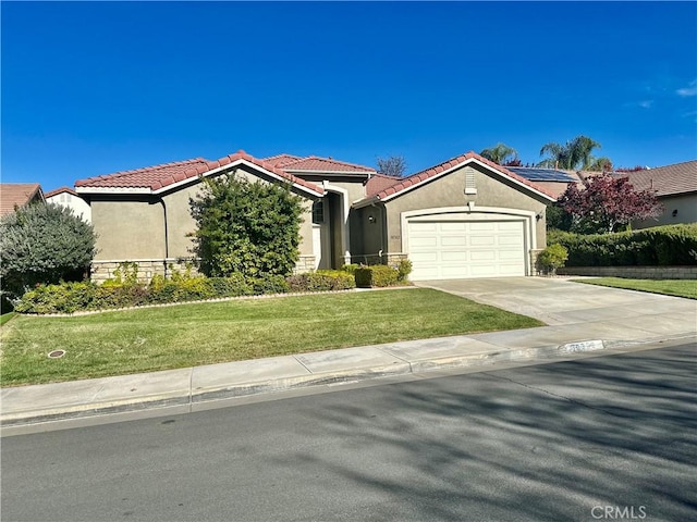 view of front of house with a front yard and a garage