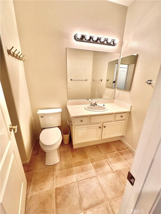 bathroom with toilet and vanity