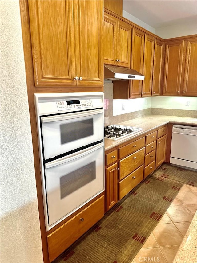 kitchen featuring white appliances and light tile patterned floors