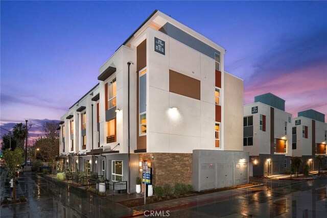 view of outdoor building at dusk