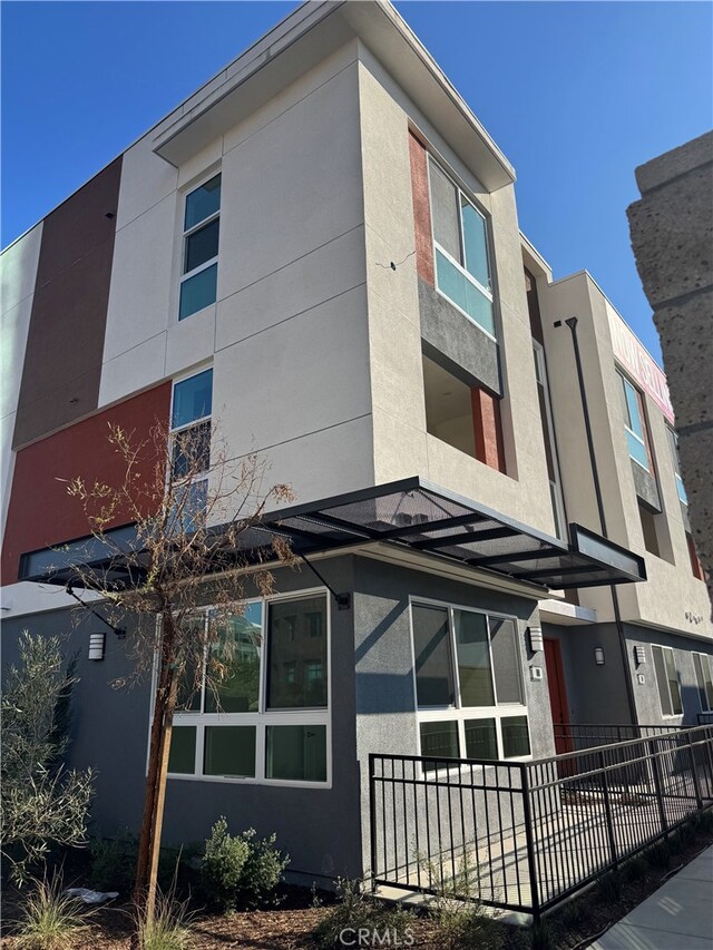 1810 E 1st St E Unit 100, Santa Ana, CA 92705 - view of side of home featuring stucco siding