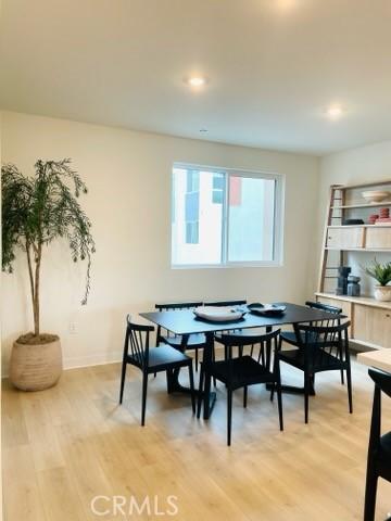 1810 E 1st St E Unit 100, Santa Ana, CA 92705 - dining room featuring light wood-style floors and baseboards