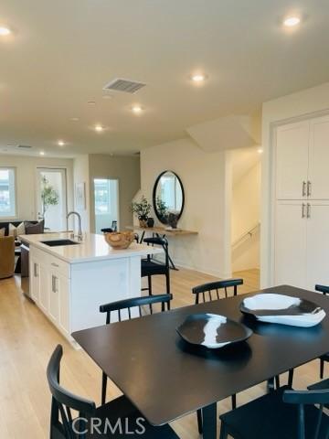 dining area featuring light wood-style floors, recessed lighting, and visible vents