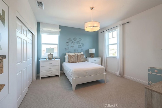 bedroom with a closet and light carpet