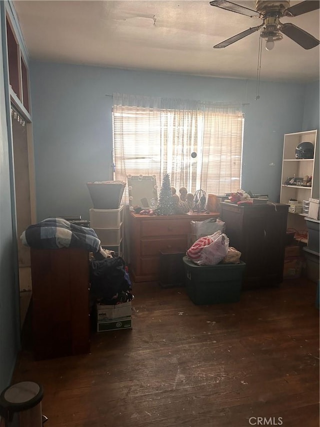 bedroom with dark hardwood / wood-style flooring and ceiling fan