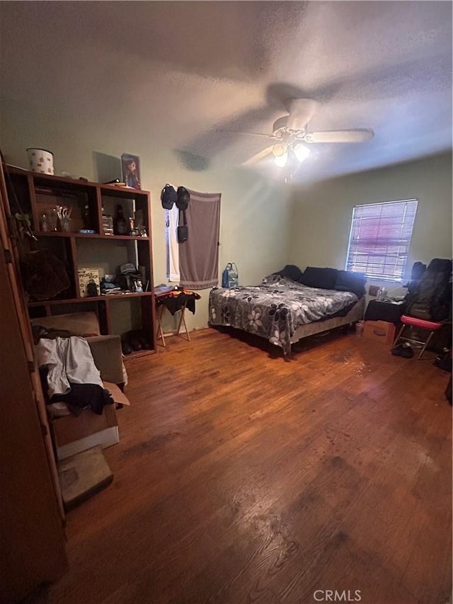 bedroom with wood-type flooring and ceiling fan