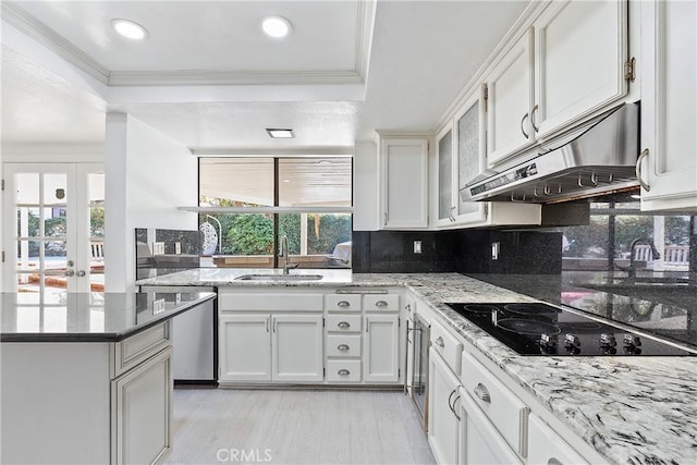 kitchen with sink, black electric stovetop, and white cabinets