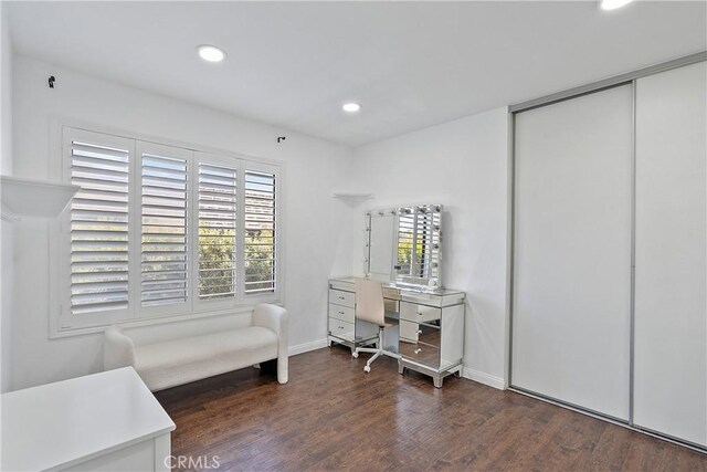 office space featuring a wealth of natural light and dark wood-type flooring