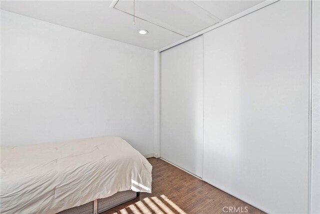 bedroom with dark hardwood / wood-style flooring