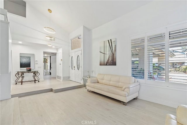 living room with hardwood / wood-style floors and vaulted ceiling