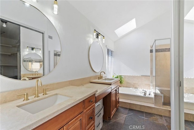 bathroom with independent shower and bath, vanity, and lofted ceiling with skylight