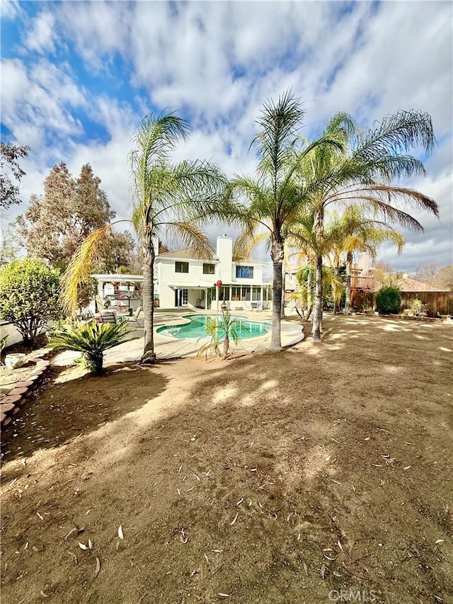 outdoor pool with a patio area