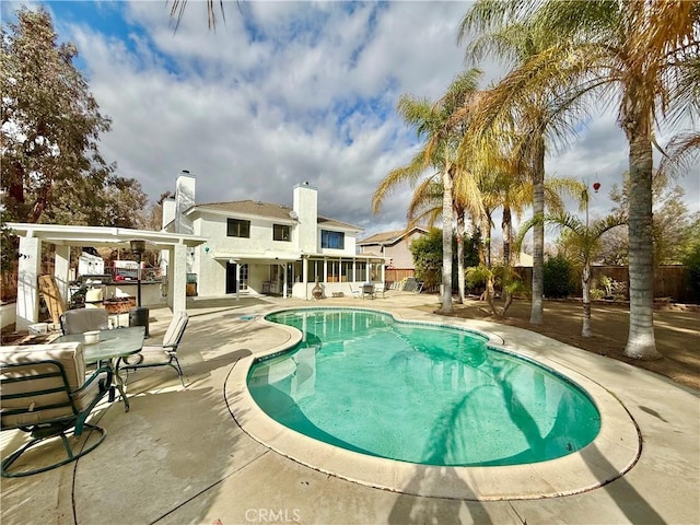 view of pool featuring a fenced in pool, fence, and a patio