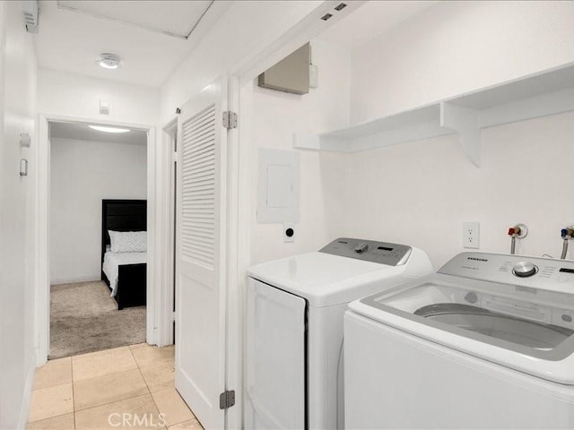 laundry area with light colored carpet, electric panel, and separate washer and dryer