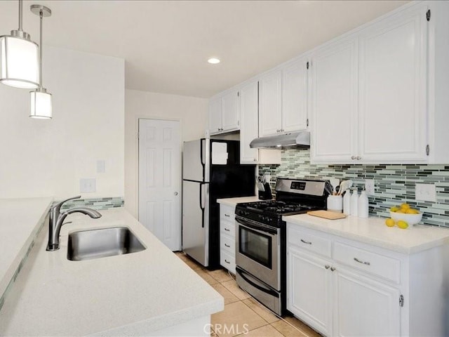 kitchen with light tile patterned floors, white cabinets, hanging light fixtures, and appliances with stainless steel finishes