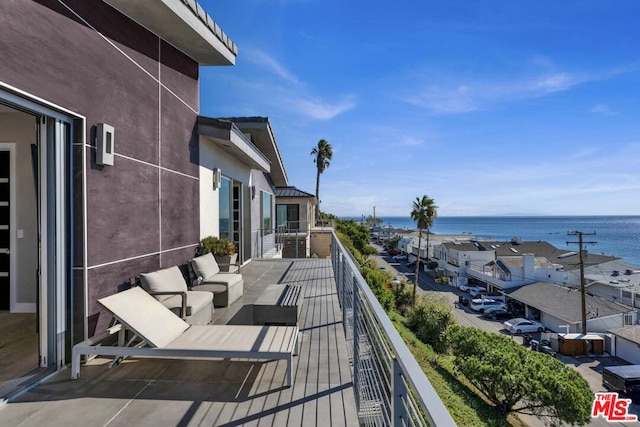 balcony featuring an outdoor hangout area and a water view