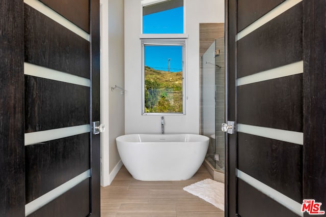 bathroom featuring shower with separate bathtub