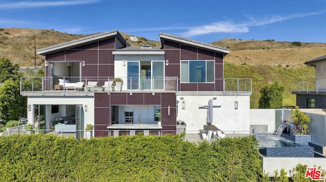 back of house featuring a balcony