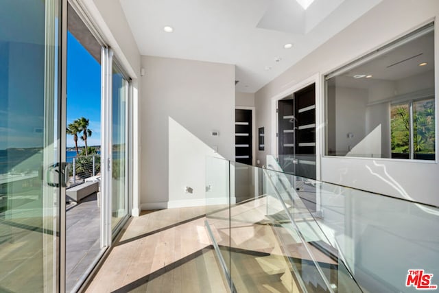 corridor featuring a wealth of natural light and a skylight