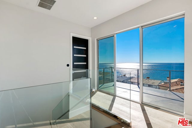 interior space featuring wood-type flooring and a water view