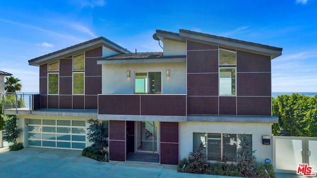 modern home featuring a garage and a balcony