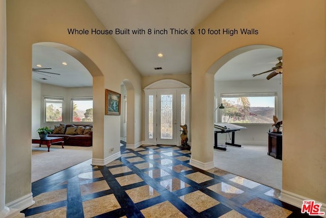 carpeted foyer featuring ceiling fan