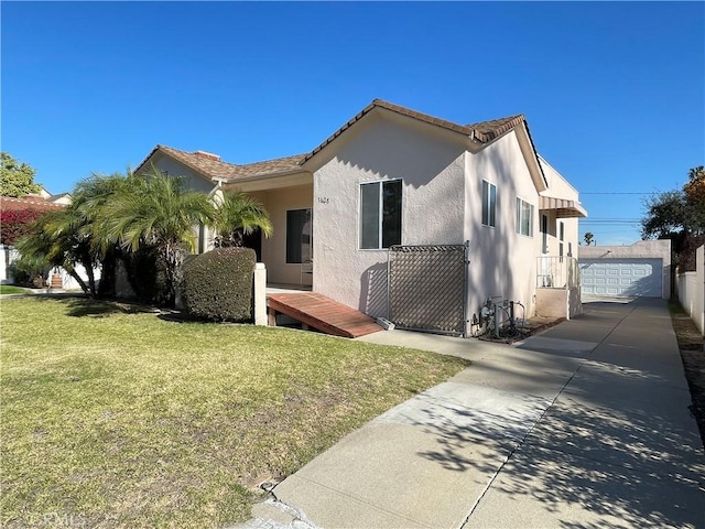 view of front facade with a garage, an outbuilding, and a front yard