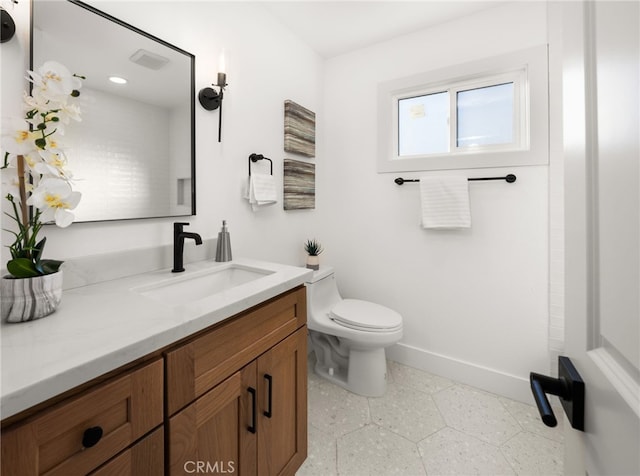 bathroom featuring vanity and toilet