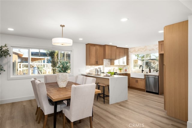 dining area featuring sink and light hardwood / wood-style flooring