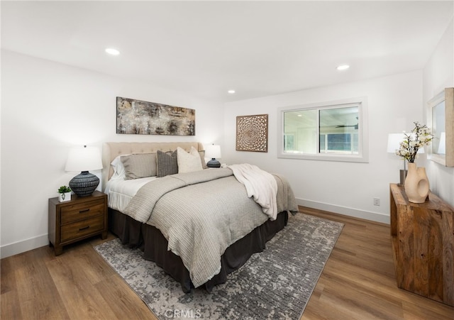 bedroom with hardwood / wood-style flooring