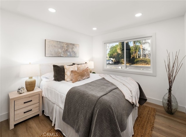 bedroom with dark wood-type flooring