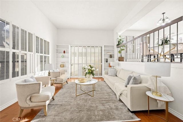 living room featuring hardwood / wood-style floors and a notable chandelier