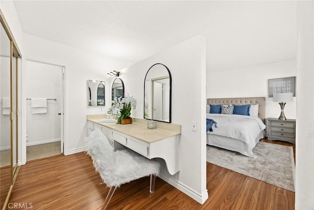 bedroom featuring hardwood / wood-style flooring and sink