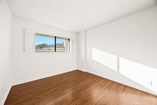 spare room with wood-type flooring