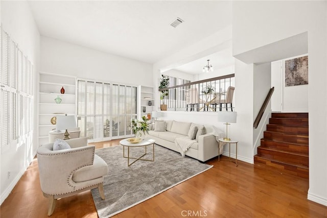 living room featuring an inviting chandelier and hardwood / wood-style flooring