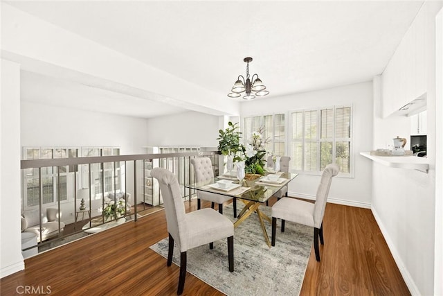 dining space with an inviting chandelier and hardwood / wood-style floors