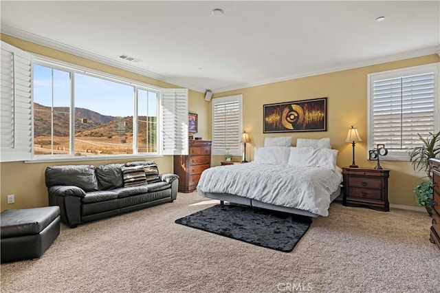 carpeted bedroom with a mountain view and ornamental molding