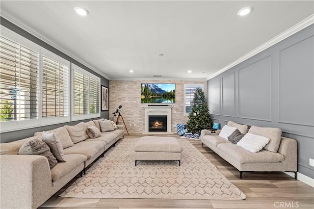 living room with light hardwood / wood-style flooring and ornamental molding