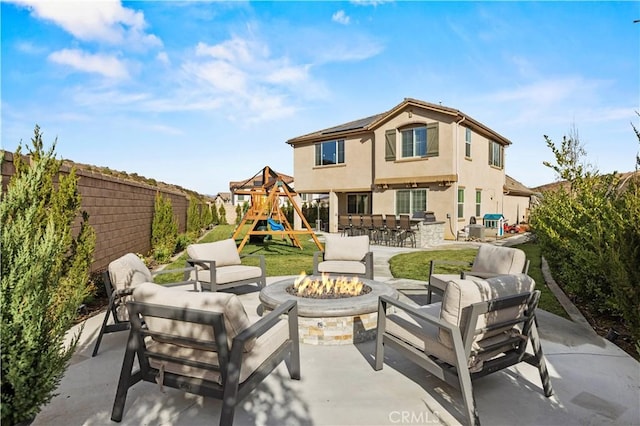 exterior space featuring a playground and an outdoor living space with a fire pit