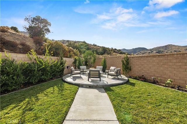 view of yard featuring a mountain view, a patio, and outdoor lounge area