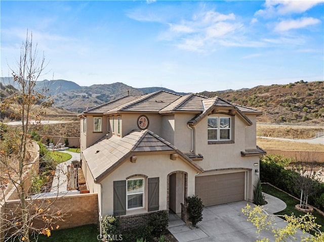 view of front of home featuring a garage and a mountain view