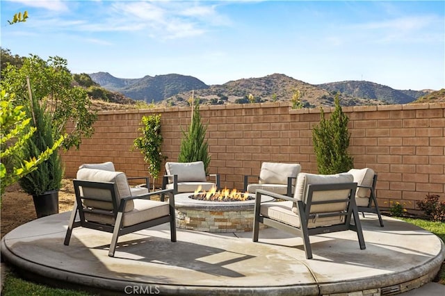 view of patio featuring a mountain view and a fire pit