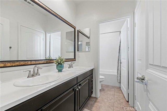 full bathroom with bathtub / shower combination, tile patterned floors, vanity, and toilet