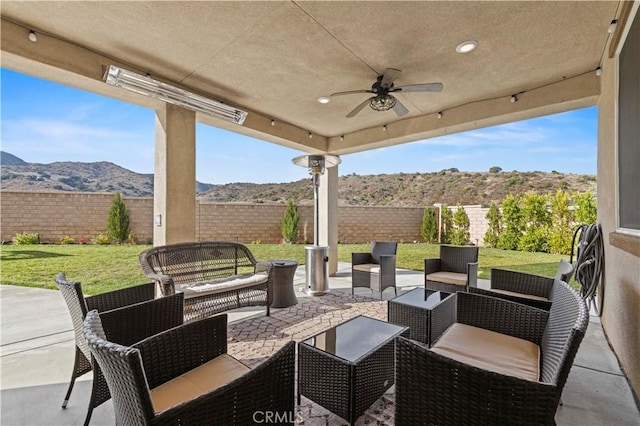 view of patio with a mountain view, ceiling fan, and an outdoor hangout area