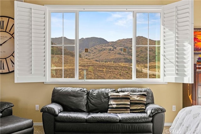 living room with a mountain view and a healthy amount of sunlight