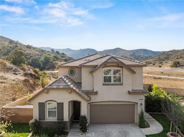 view of front of property featuring a garage and a mountain view