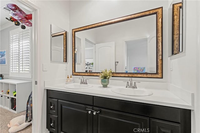 bathroom with vanity and ornamental molding