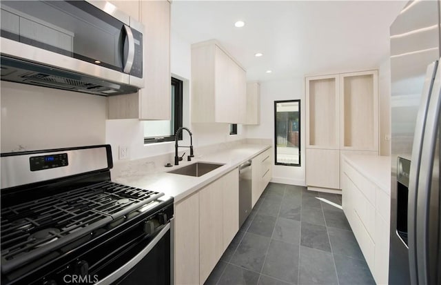 kitchen featuring sink, stainless steel appliances, and dark tile patterned floors